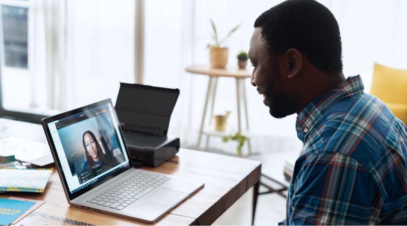 Satisfied worker avoiding quiet quitting by having a virtual work meeting from home