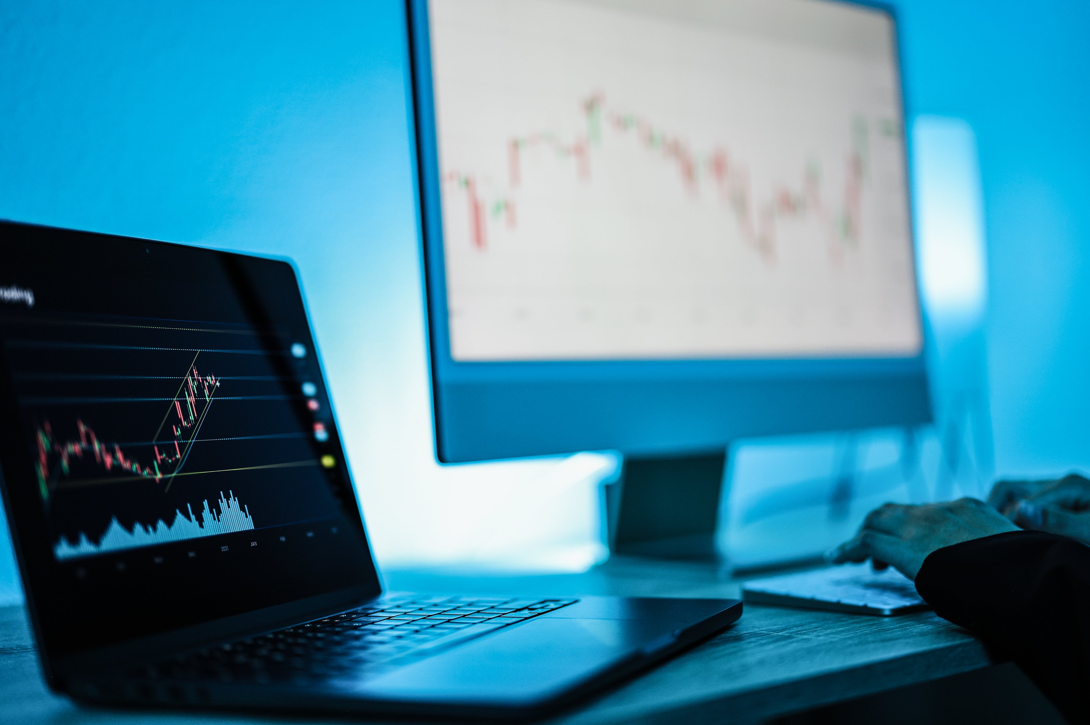 Computers displaying RegTech and risk management graphs